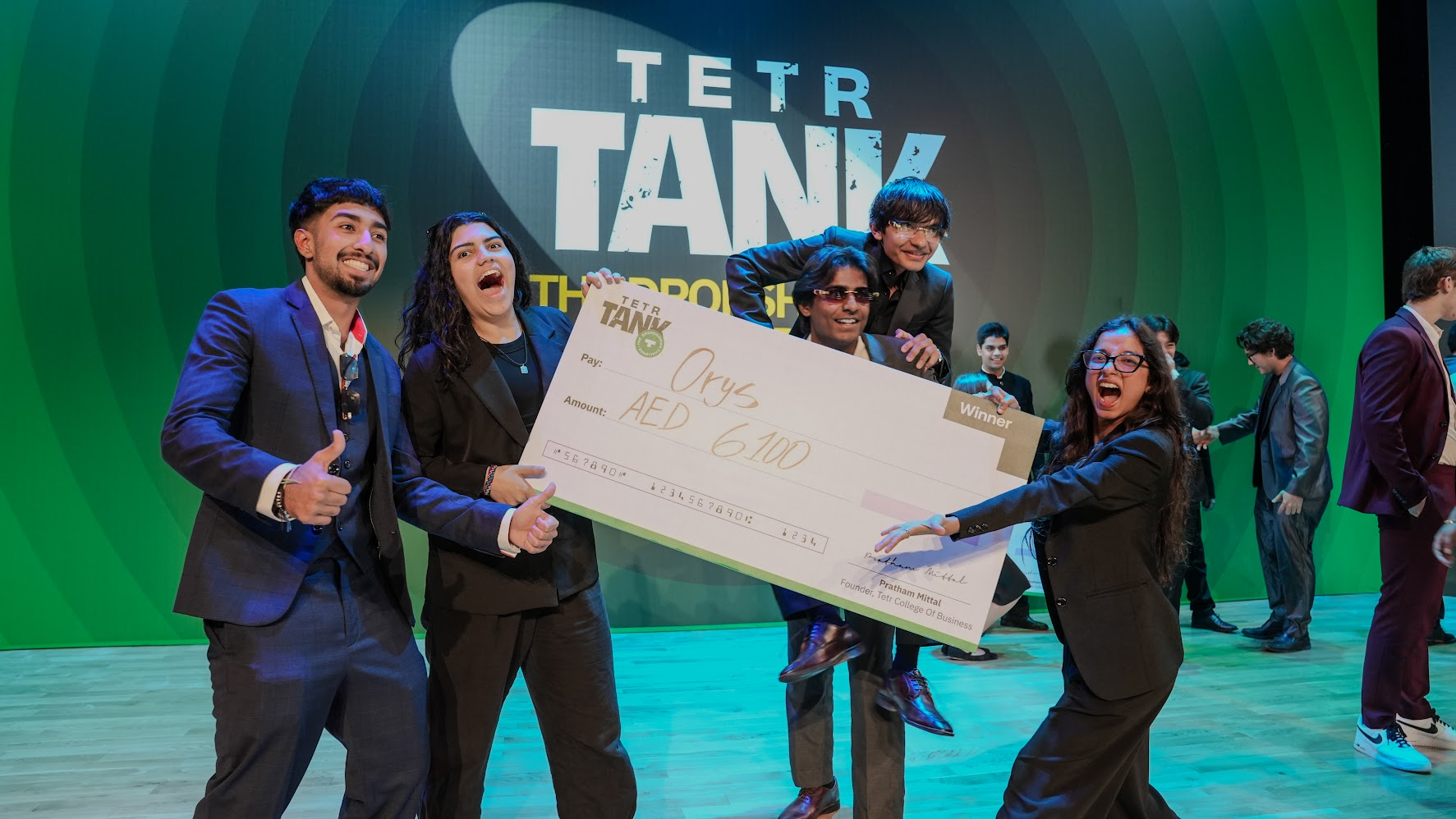 FounderCamp winners celebrating on stage during program day 7